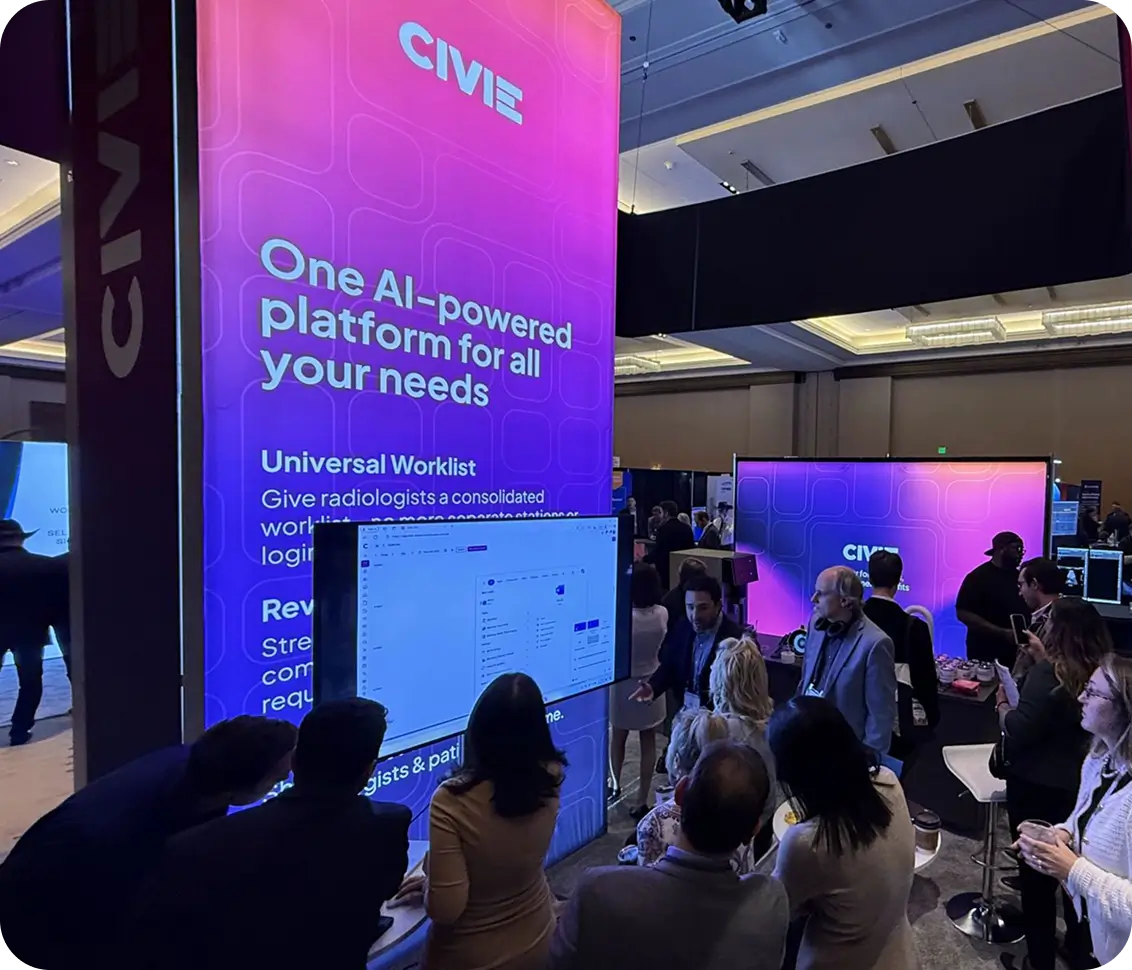 Visitors gather around the CIVIE booth at a tech conference as a presenter demonstrates an AI-powered healthcare platform on a large screen.